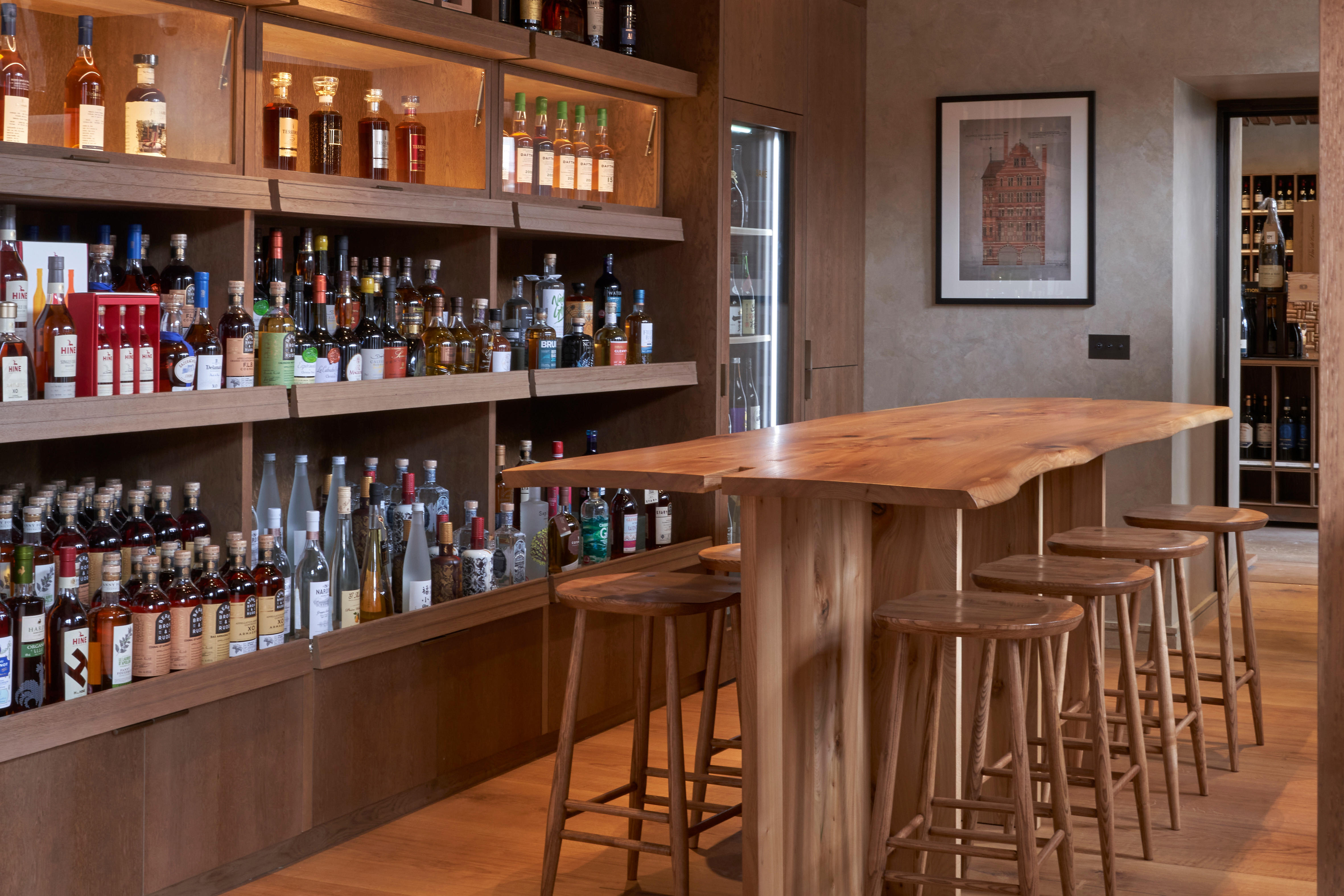 Six bottles of old and rare spirits against a blurred shop background. 