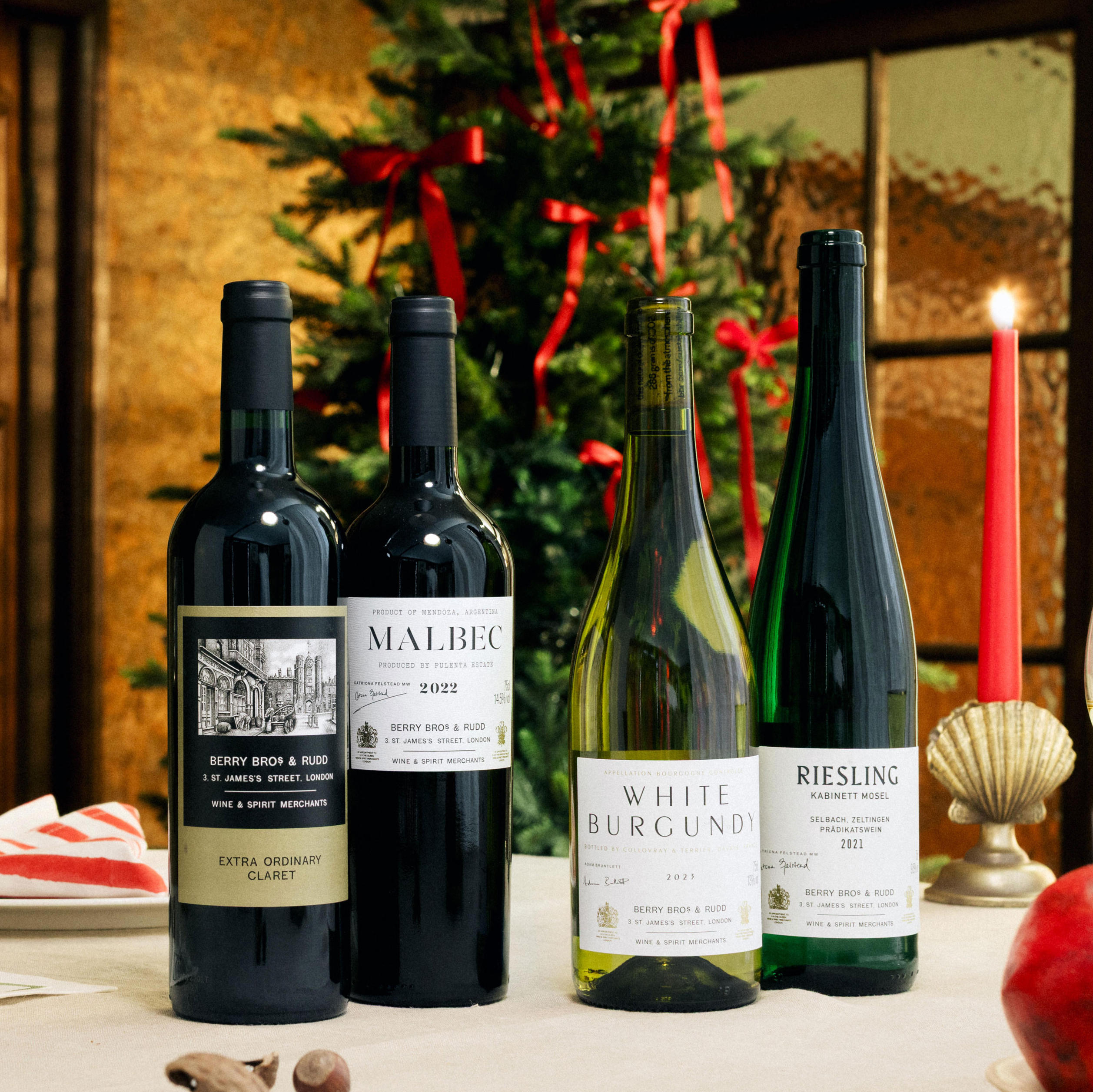 Bottles of our Own Selection wines against a Christmas tree. 
