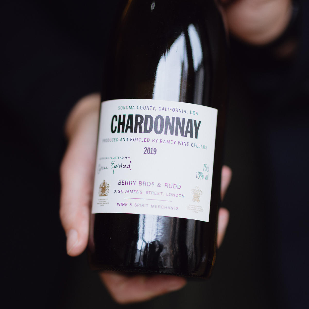 A photo of our Own Selection Sonoma Chardonnay, held up to the camera so that the label is centre of the picture.