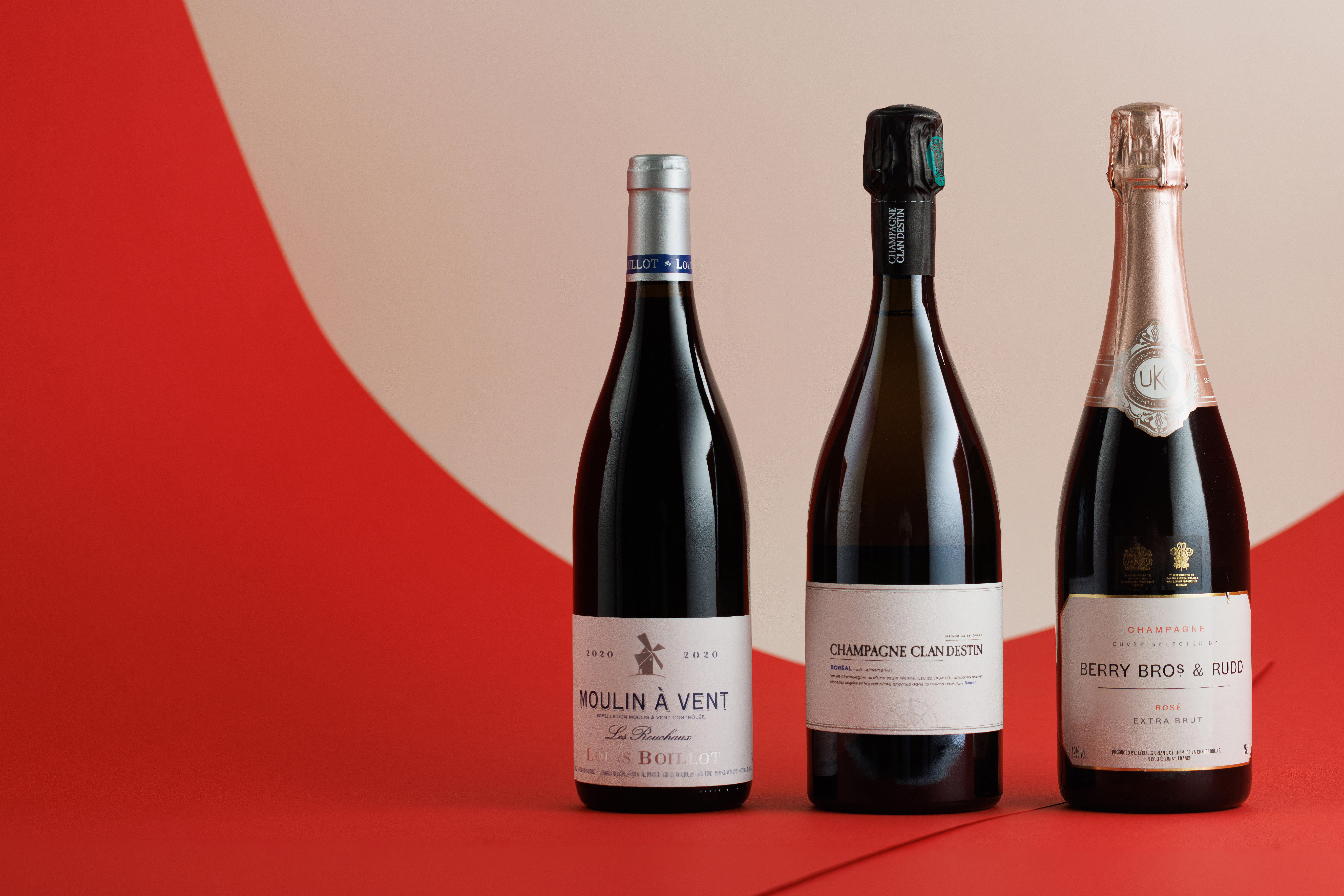 A selection of red and Champagne bottles and a No. 3 gin bottle against a festive background. 