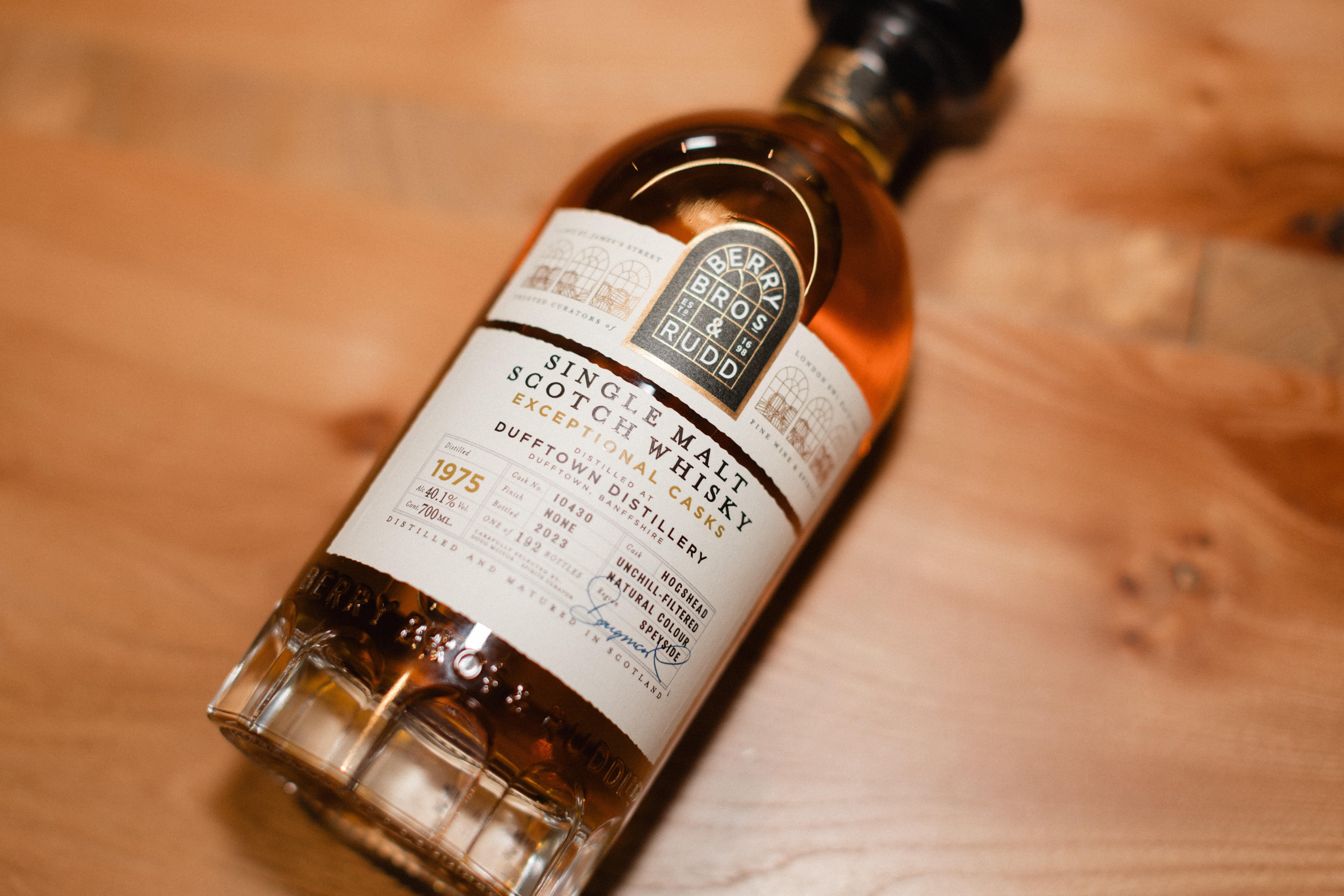 A bottle of Berry Bros. & Rudd Single Malt Scotch Whisky from the Exceptional Casks range, shown lying on a wooden surface.