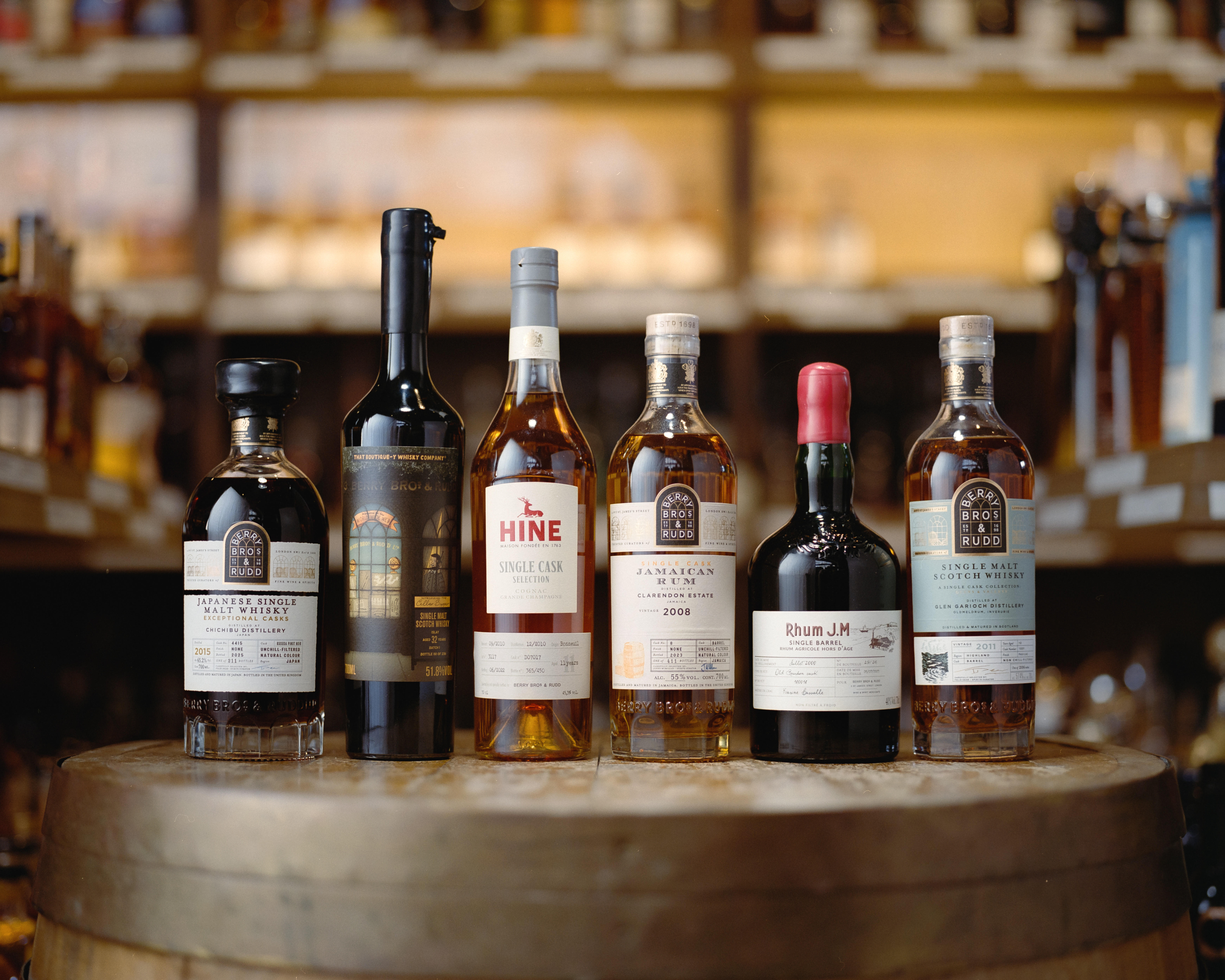 A selection of six Berry Bros. & Rudd Own Selection spirits, including Japanese Single Malt Whisky, North British Distillery Scotch, Hine Single Cask Cognac, Jamaican Rum from Clarendon Estate, Rhum J.M., and a Single Malt Scotch Whisky.