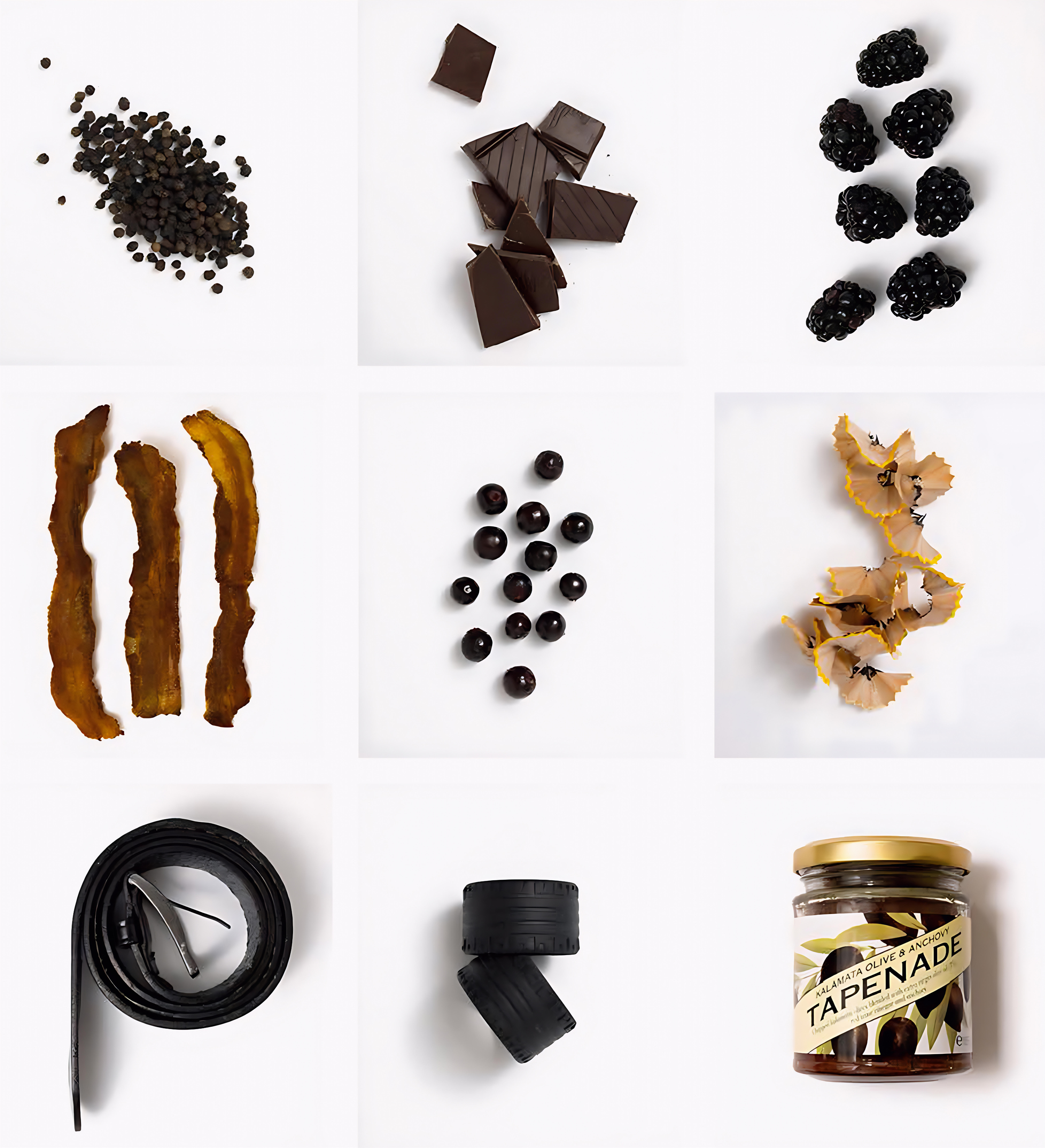 Close-up of ripe Syrah grape bunches hanging on the vine, with deep purple skins and sunlit green leaves in the background